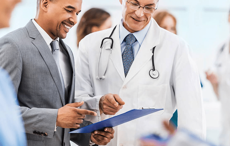 Clinician reviewing patient data on a tablet in a healthcare facility